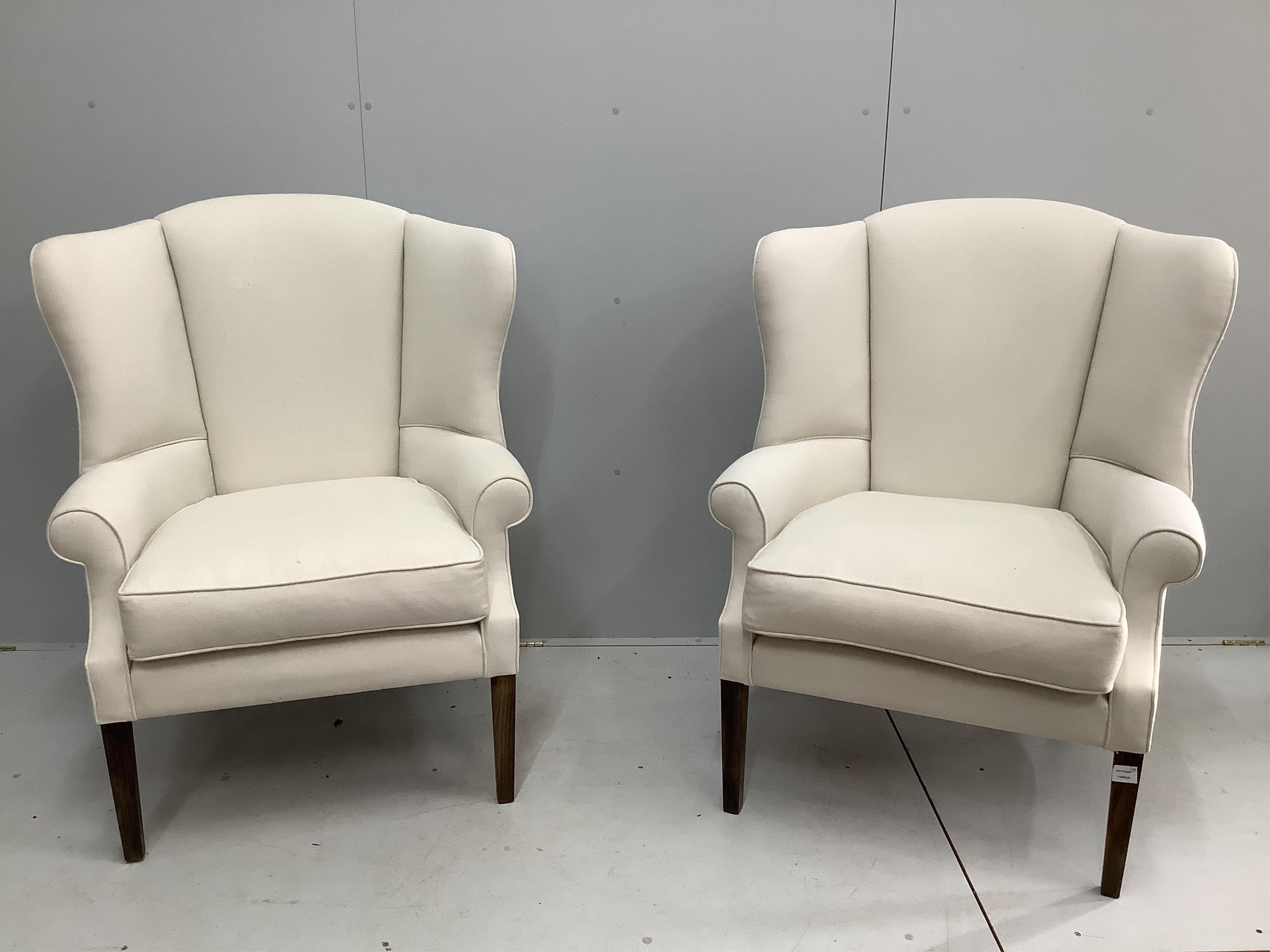 A pair of modern upholstered wingback armchairs, width 86cm, depth 74cm, height 114cm. Condition - good